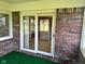 Covered patio with brick walls and a sliding door that provides access to the kitchen at 641 S Grant St, Brownsburg, IN 46112
