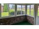 Enclosed patio with brick construction and screened windows, offering a bright and airy space at 641 S Grant St, Brownsburg, IN 46112