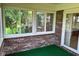 Bright and airy sunroom with large windows and an exit door, offering a view of the yard at 641 S Grant St, Brownsburg, IN 46112