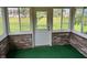 Bright sunroom featuring brick walls, ample windows, and a door to the outside at 641 S Grant St, Brownsburg, IN 46112