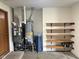 View of the water heater and furnace, along with shelving in the garage at 641 S Grant St, Brownsburg, IN 46112