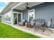 Inviting covered back porch with comfortable seating, perfect for outdoor relaxation and entertaining at 655 N Sobota Way, Trafalgar, IN 46181