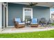 Cozy back porch with comfortable seating and a ceiling fan, perfect for relaxation and outdoor enjoyment at 655 N Sobota Way, Trafalgar, IN 46181