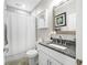 Clean bathroom features a granite countertop, white cabinets, and decorative mirror at 655 N Sobota Way, Trafalgar, IN 46181