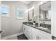Elegant bathroom with double sink vanity, granite countertop, and framed mirrors at 655 N Sobota Way, Trafalgar, IN 46181