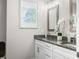 Stylish bathroom featuring double sinks with granite countertops and decorative mirrors at 655 N Sobota Way, Trafalgar, IN 46181