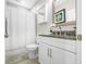 Granite countertop with mirror and white cabinetry. Includes a shower with curtain at 655 N Sobota Way, Trafalgar, IN 46181