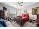 Cozy bedroom with red bedding, a ceiling fan, a window, and decor at 655 N Sobota Way, Trafalgar, IN 46181
