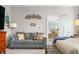 Comfortable bedroom featuring a cozy sitting area with a sofa and view into the dining area at 655 N Sobota Way, Trafalgar, IN 46181