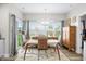 Bright dining area with a view to the backyard, modern decor, and an adjacent kitchen at 655 N Sobota Way, Trafalgar, IN 46181