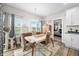 Dining space with backyard views, and an adjacent hallway to the main bedroom at 655 N Sobota Way, Trafalgar, IN 46181