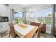 Bright dining room features backyard views, modern light fixtures, and stylish decor at 655 N Sobota Way, Trafalgar, IN 46181