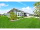 Exterior view of a home with blue siding and well-manicured landscaping with a concrete driveway at 655 N Sobota Way, Trafalgar, IN 46181