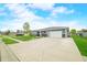 Single-story home with a gray garage door and well-manicured lawn at 655 N Sobota Way, Trafalgar, IN 46181