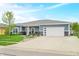 Charming single-story home with blue siding, stone accents, and an attached two car garage at 655 N Sobota Way, Trafalgar, IN 46181