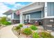 Cozy front porch with stylish seating, stone details, and well-maintained landscaping at 655 N Sobota Way, Trafalgar, IN 46181