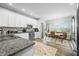 Bright kitchen with granite counters, stainless appliances, and adjacent dining area at 655 N Sobota Way, Trafalgar, IN 46181