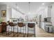 Eat-in kitchen with bar stool seating at the island and stainless steel appliances at 655 N Sobota Way, Trafalgar, IN 46181