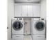 Well lit laundry room with gray tile floor and modern washer and dryer set at 655 N Sobota Way, Trafalgar, IN 46181