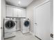 Clean laundry room with gray tile floor and a modern washer and dryer set at 655 N Sobota Way, Trafalgar, IN 46181