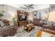 Cozy living room featuring leather recliners, a ceiling fan, and a stylish area rug at 655 N Sobota Way, Trafalgar, IN 46181