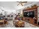 Open living space with leather recliners, a large TV, and an adjacent eat in kitchen with a breakfast bar at 655 N Sobota Way, Trafalgar, IN 46181