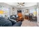 Cozy living room featuring comfortable seating, a ceiling fan, and natural light from surrounding windows at 655 N Sobota Way, Trafalgar, IN 46181