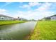 A serene water view from this property, showing calm waters and manicured lawns at 655 N Sobota Way, Trafalgar, IN 46181
