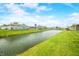 Beautiful water view lined with green lawn and attractive homes in a peaceful setting at 655 N Sobota Way, Trafalgar, IN 46181