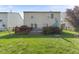 A backyard with a deck, grass, and partial fence at 6608 Sonesta Dr, Indianapolis, IN 46217
