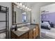 Well-lit bathroom featuring a vanity with decorative mirror, view of bedroom, and tile accents at 6608 Sonesta Dr, Indianapolis, IN 46217