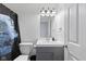 Well-lit bathroom with a modern vanity, decorative shower curtain, and updated fixtures at 6608 Sonesta Dr, Indianapolis, IN 46217