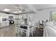 Modern kitchen with stainless steel appliances, white cabinets, and an adjacent dining area at 6608 Sonesta Dr, Indianapolis, IN 46217