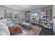 Cozy living room with a large sofa, entertainment center, and bright windows at 6608 Sonesta Dr, Indianapolis, IN 46217