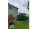 Spacious backyard featuring lush green grass, mature trees, and a cozy deck area at 6730 Nw Shanghai Cir, Indianapolis, IN 46268