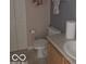 Cozy bathroom featuring a toilet, vanity with sink, and a neutral color scheme at 6730 Nw Shanghai Cir, Indianapolis, IN 46268