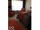 Comfortable bedroom with modern decor, a plush rug, and two inviting armchairs at 6730 Nw Shanghai Cir, Indianapolis, IN 46268