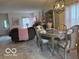 Elegant dining area with a stylish chandelier, comfortable seating, and inviting decor at 6730 Nw Shanghai Cir, Indianapolis, IN 46268
