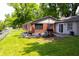 Brick house featuring a wooden deck and plenty of green space at 6801 Shalimar Ct, Indianapolis, IN 46214