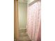 View of a bathtub with a pink heart-themed shower curtain at 6801 Shalimar Ct, Indianapolis, IN 46214