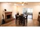 Cozy dining room with a fireplace, wood floors, and bright natural light at 6801 Shalimar Ct, Indianapolis, IN 46214
