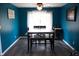 Inviting dining room with wood floors, bright blue walls, and a ceiling fan at 6801 Shalimar Ct, Indianapolis, IN 46214