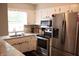 Modern kitchen with stainless steel appliances, granite counters, and white cabinetry at 6801 Shalimar Ct, Indianapolis, IN 46214