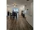 Open living room featuring dining space, modern appliances, and hardwood floors at 6801 Shalimar Ct, Indianapolis, IN 46214
