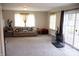 Bright and spacious living room with a couch and sliding glass doors to a patio at 6801 Shalimar Ct, Indianapolis, IN 46214