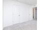 A simple yet stylish bedroom boasts neutral carpet and paint, complemented by modern doors and trim at 7151 Firestone Rd, Whitestown, IN 46052