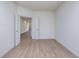 Neutral bedroom with wood-look floors, white walls, and an open doorway at 7151 Firestone Rd, Whitestown, IN 46052