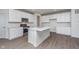 Well-equipped kitchen with white cabinets, stainless steel appliances, and center island with seating at 7151 Firestone Rd, Whitestown, IN 46052