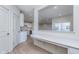 Modern kitchen boasts white cabinets, quartz countertops, open layout, and built in desk area at 7151 Firestone Rd, Whitestown, IN 46052