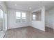 Bright living area with wood-look flooring, neutral walls, and sliding glass doors to the backyard at 7151 Firestone Rd, Whitestown, IN 46052